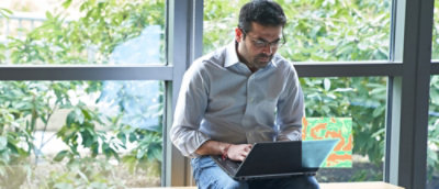A person sitting in front of a laptop.