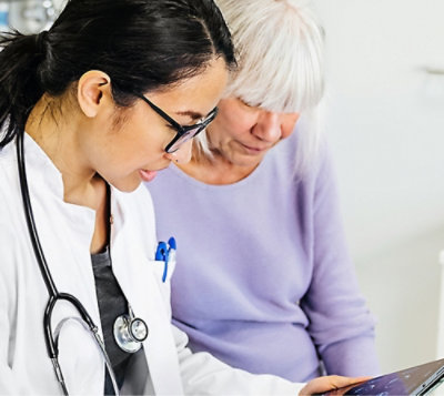 A doctor and a patient looking at a tablet.