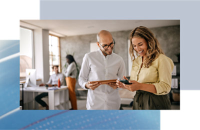 Two persons checking something in a smiling face.