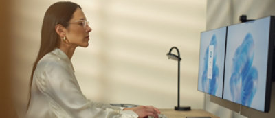 A woman sitting at a desk using a computer.