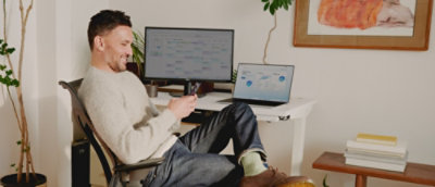 A man sitting in a chair with his feet on the desk.