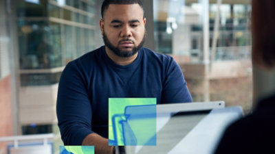 Person working on a laptop in a modern office environment.