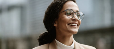 A close-up of a person wearing glasses and a suit.