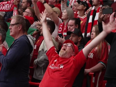 A group of people on a football field wearing red T-shirt