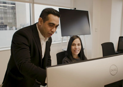 Two persons are looking for laptop