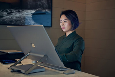 A person sitting at a desk with a computer.