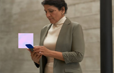 A woman in a suit holding a phone.