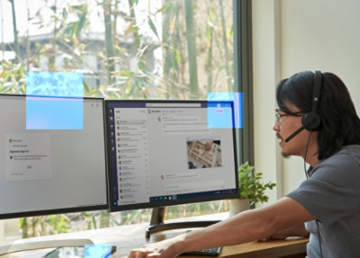 A man working on two desktops