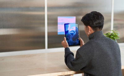 A person looking into a tab screen.