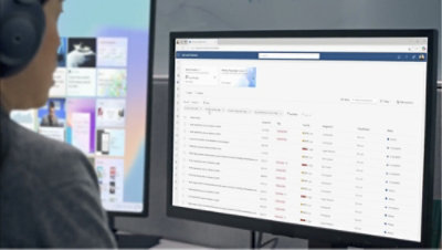 A person wearing headphones looking at a computer screen displaying a website.