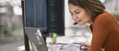 A woman looking at a laptop.