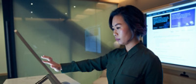 A person using a touch screen with a hand visible.