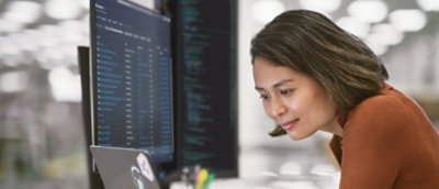 A woman looking at a computer screen.