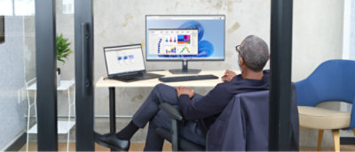 A man sitting at a desk with a computer.