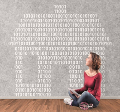 A person sitting on the floor with a tablet in her hand