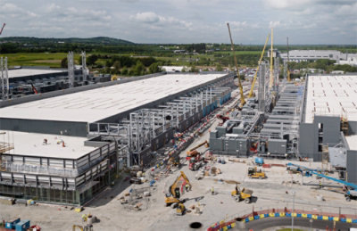 A building under construction with construction equipment.