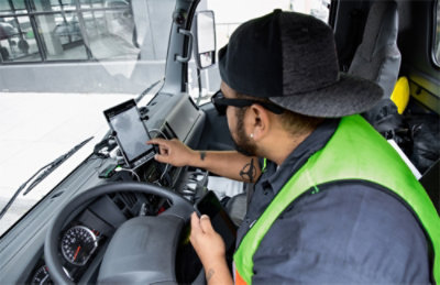 A man using a tablet in a truck.