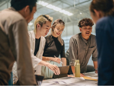 A person sitting at a desk using a laptop.