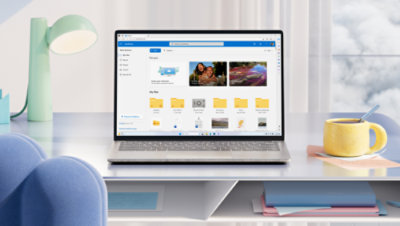 A laptop on a white desk displays a cloud storage interface.