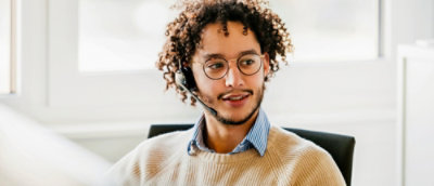 A person wearing headphone working in office.