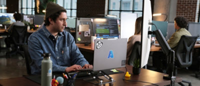 A man sitting at a desk with a laptop.