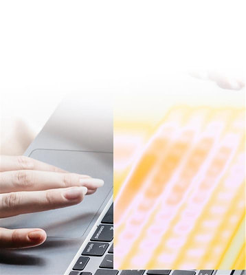 A person typing on a laptop keyboard.