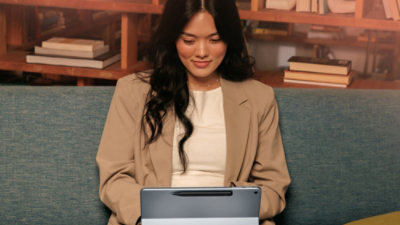 A person sitting on a couch using a laptop.
