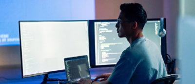A man sitting at a desk using a computer.