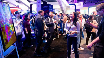 A group of people in a room at a convention.