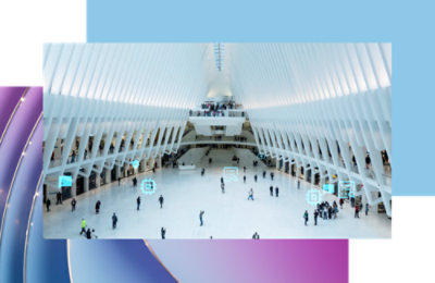 A large white building with people walking nearby.