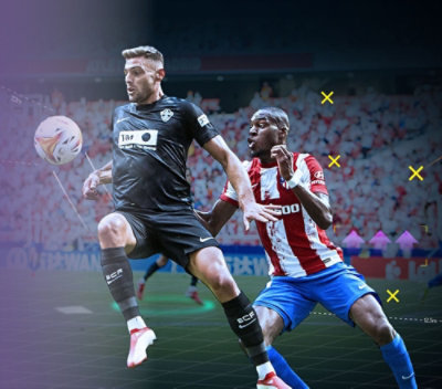 Two men playing football in a stadium