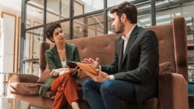 A man and woman sitting on a couch.