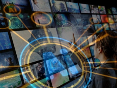 An individual looks at a television showcasing a variety of different visuals.