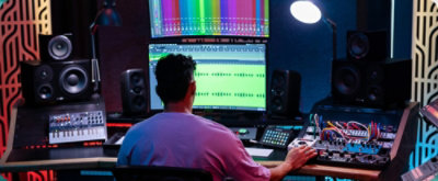 A person sitting at a desk with a computer screen.