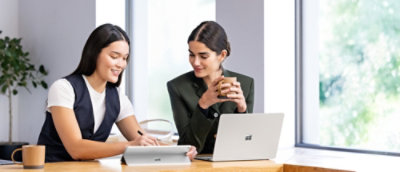 A group of women looking at a laptop.