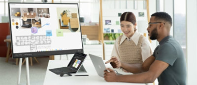 A person pointing at a computer and explaining.