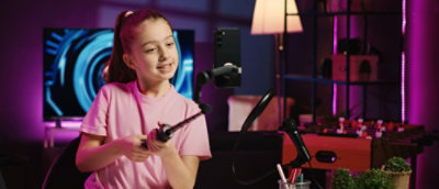 A person in a pink shirt holding a pole.