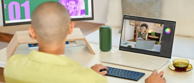 A person sitting at a desk using a laptop.