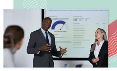 A man in a suit giving a presentation to a group in a meeting.