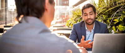 A man sitting outside in a cafe.