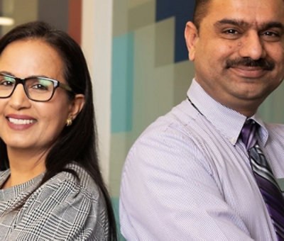 Colleagues standing back to back