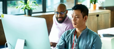 A group of men looking at a computer screen.