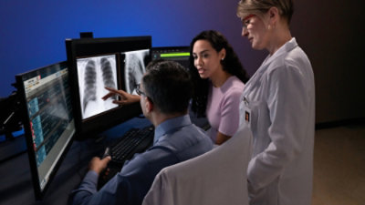 People looking at the screen and discussing