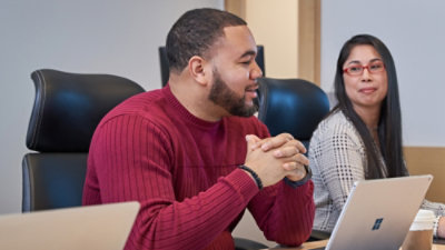 Team members discussing work around a desk.