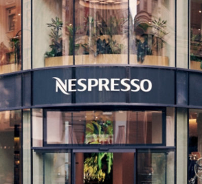 Nespresso storefront with glass facade and brand signage above the entrance.