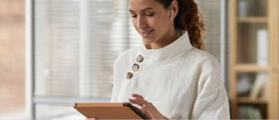 A women holding a tab.