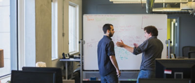 A person standing in front of a whiteboard