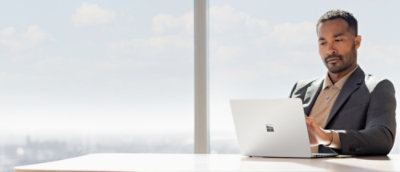 A man wearing suit working on the laptop 