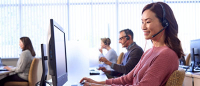 In the office multiple people working on computer.