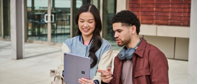A man and women working on a laptop.